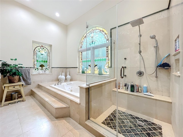 bathroom featuring shower with separate bathtub