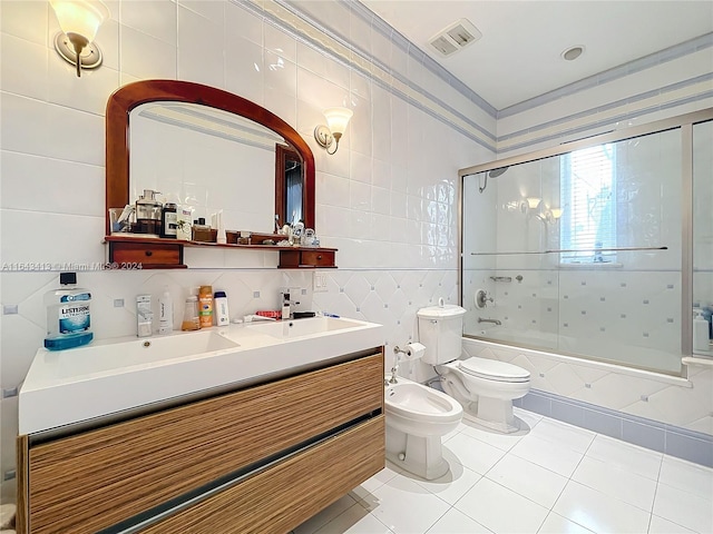 full bathroom featuring a bidet, tile patterned floors, bath / shower combo with glass door, toilet, and tile walls