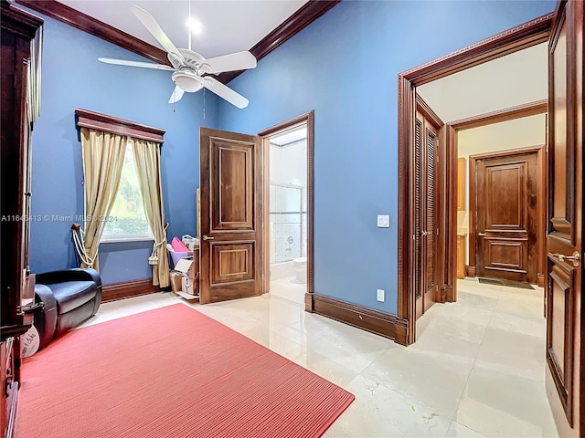 bedroom featuring ceiling fan, crown molding, and ensuite bathroom