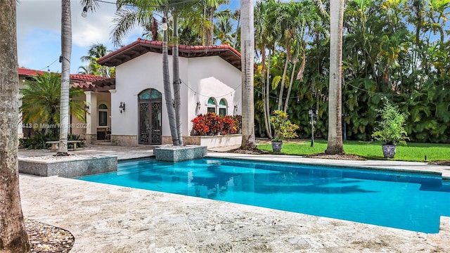 view of swimming pool featuring french doors and a patio