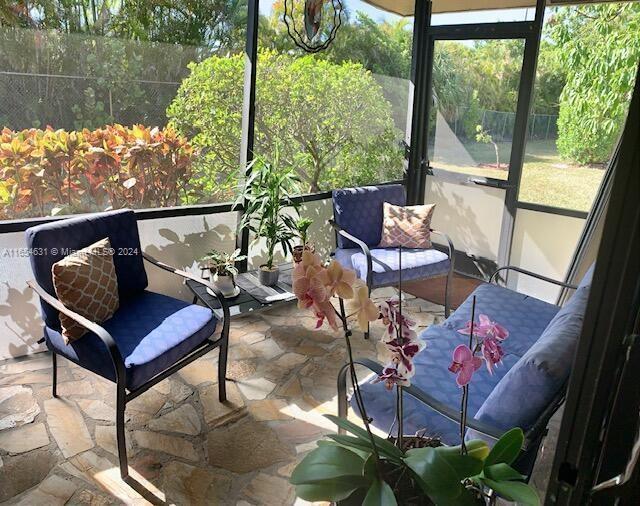 sunroom / solarium featuring a healthy amount of sunlight