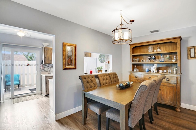 dining room featuring hardwood / wood-style floors and ceiling fan with notable chandelier