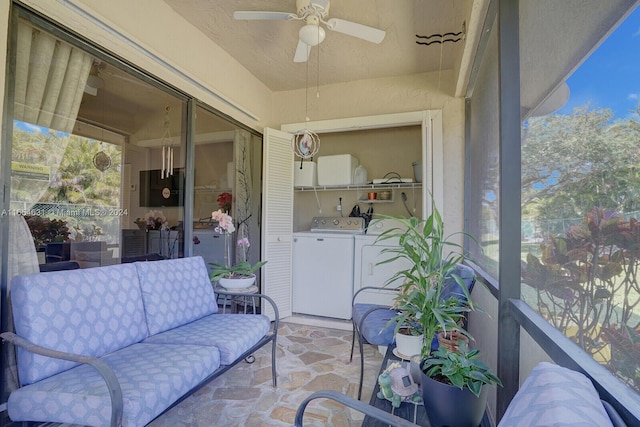 sunroom / solarium featuring independent washer and dryer and ceiling fan