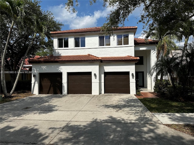 mediterranean / spanish-style home with a garage