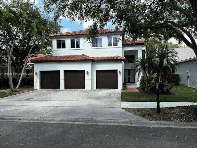 mediterranean / spanish-style house with a garage