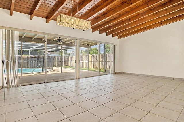 spare room with wooden ceiling, beamed ceiling, ceiling fan, and light tile patterned flooring