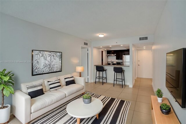 bedroom with a closet and light tile patterned flooring