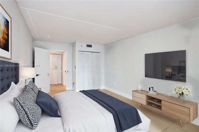 tiled bedroom with a closet