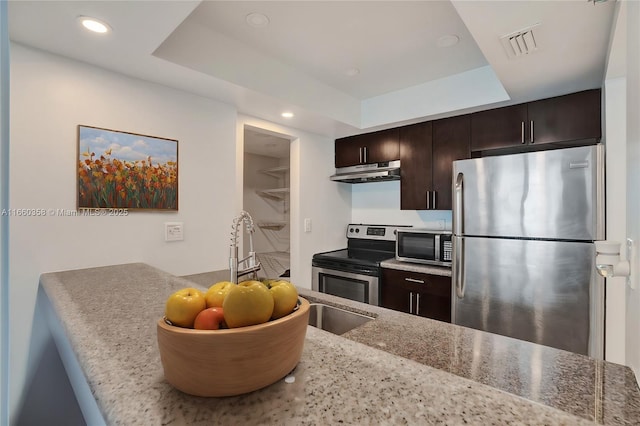 850 N Miami Ave Unit W-1810, Miami, FL 33136 - kitchen featuring a tray ceiling, appliances with stainless steel finishes, dark brown cabinetry, and under cabinet range hood
