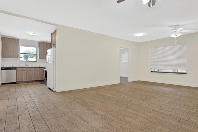 unfurnished living room with light hardwood / wood-style flooring and ceiling fan