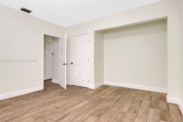 unfurnished bedroom with light wood-type flooring