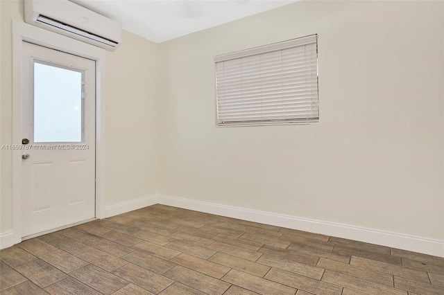 interior space featuring hardwood / wood-style floors and an AC wall unit