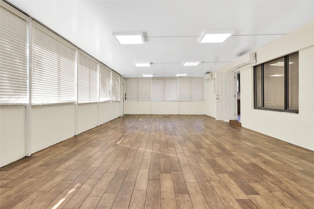 interior space featuring an AC wall unit and hardwood / wood-style floors