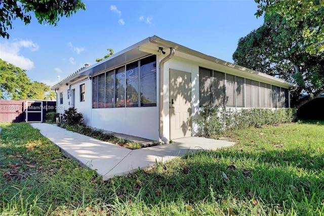 view of home's exterior with a sunroom