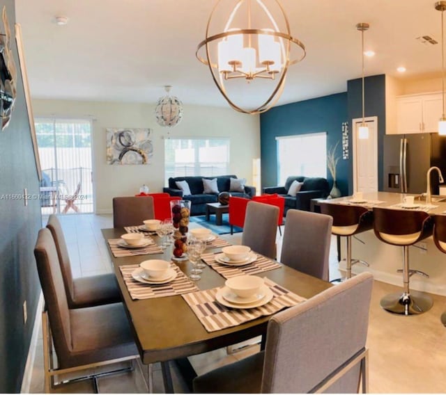 dining space with sink and a chandelier