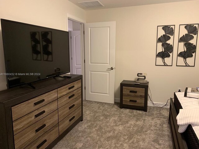 bedroom featuring dark colored carpet and visible vents