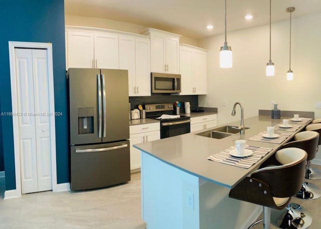 kitchen with sink, appliances with stainless steel finishes, and white cabinetry