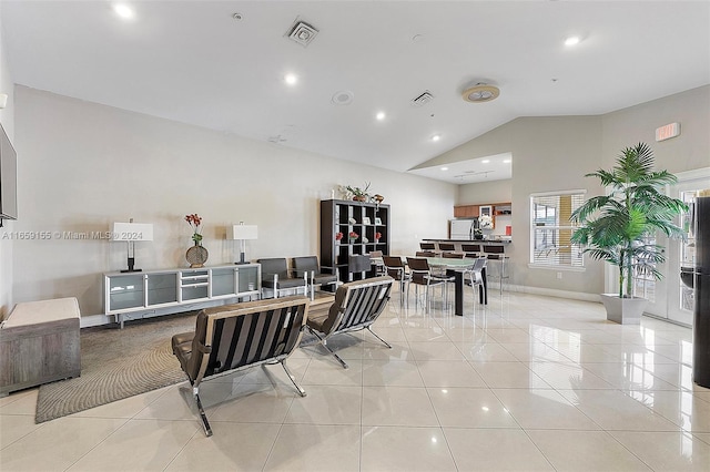 tiled dining space with high vaulted ceiling