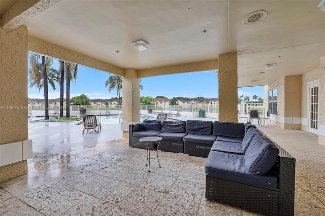 view of patio / terrace with a community pool and a water view