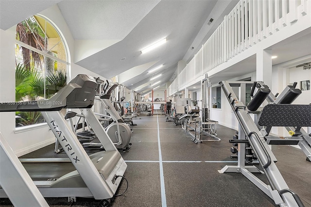 gym with a wealth of natural light and a textured ceiling