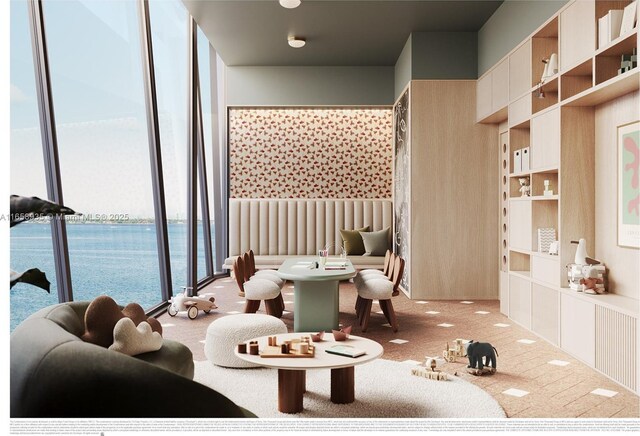 carpeted living room featuring a water view