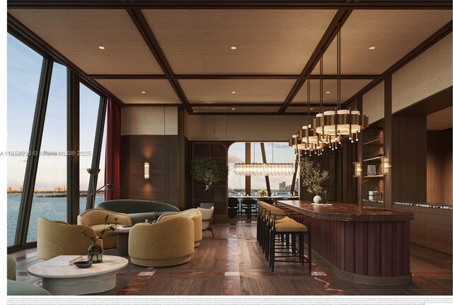 living room with a water view, floor to ceiling windows, coffered ceiling, and a chandelier