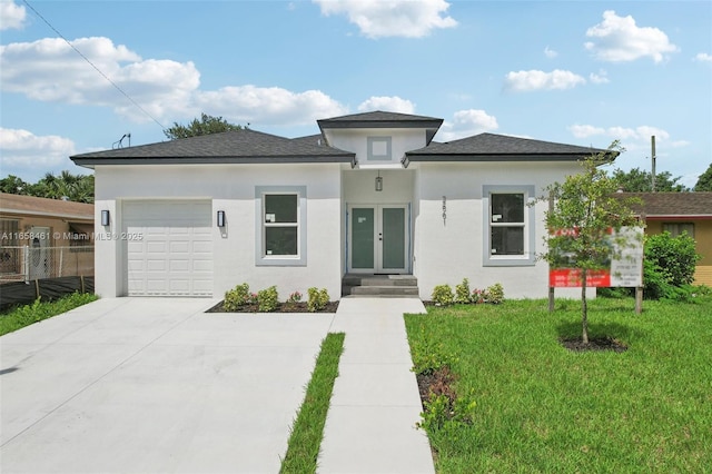 prairie-style house with stucco siding, concrete driveway, fence, a garage, and a front lawn