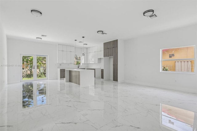 unfurnished living room featuring sink