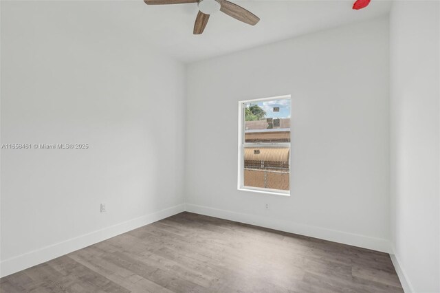 unfurnished room with ceiling fan and hardwood / wood-style flooring