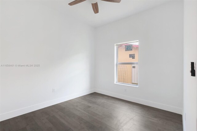 empty room featuring dark hardwood / wood-style flooring and ceiling fan