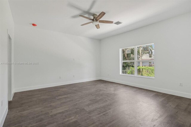 spare room with ceiling fan and dark hardwood / wood-style floors