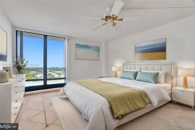 tiled bedroom featuring ceiling fan