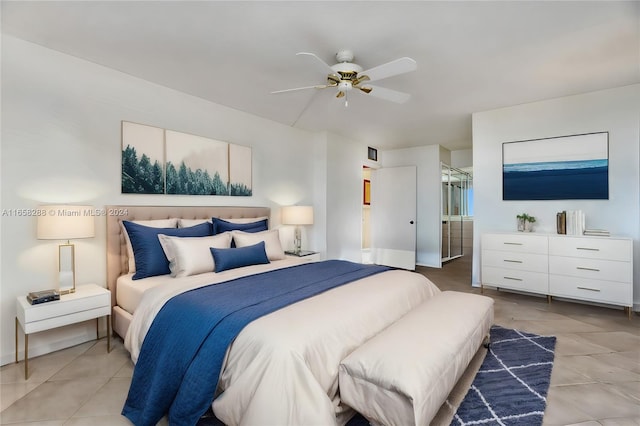 bedroom featuring ceiling fan, light tile patterned floors, and connected bathroom