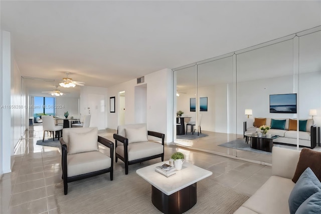 tiled living room with ceiling fan