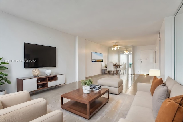 tiled living room with ceiling fan