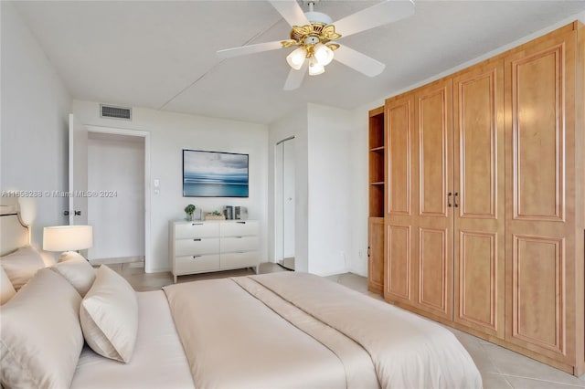 bedroom with ceiling fan and light tile patterned flooring