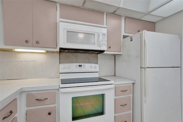 kitchen with a drop ceiling and white appliances