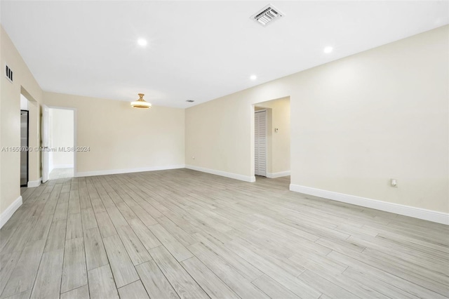 unfurnished room with light hardwood / wood-style flooring