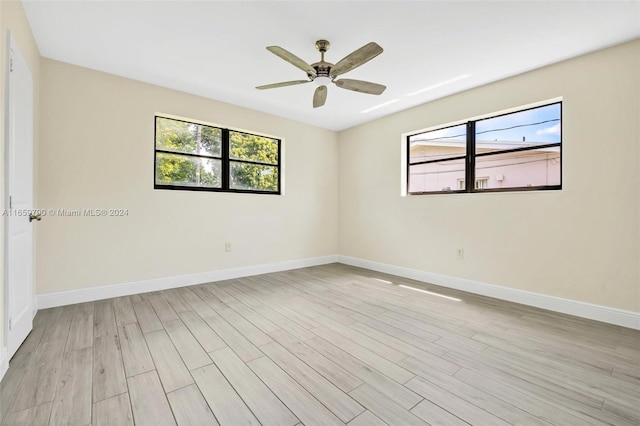 spare room with light wood-type flooring and ceiling fan