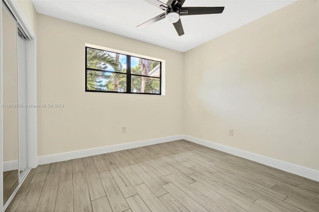 spare room with ceiling fan and light wood-type flooring