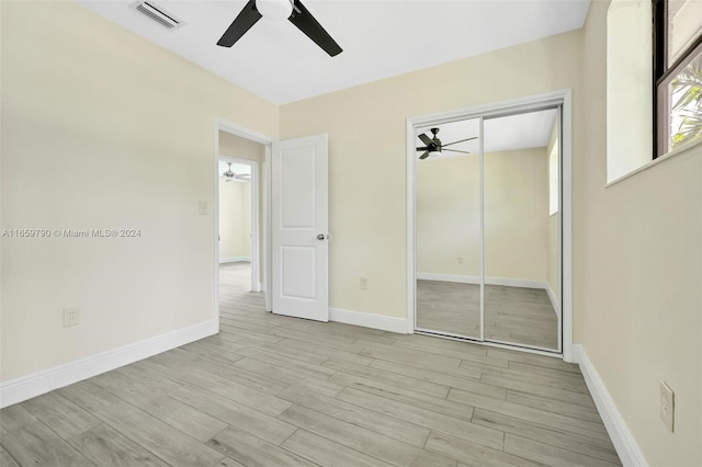 unfurnished bedroom featuring a closet, ceiling fan, and light hardwood / wood-style floors