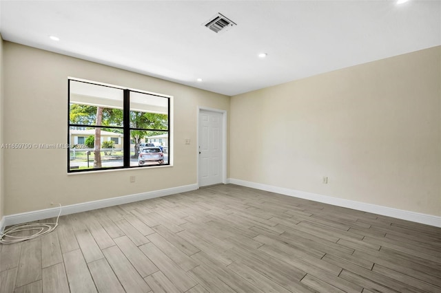 empty room with light hardwood / wood-style flooring