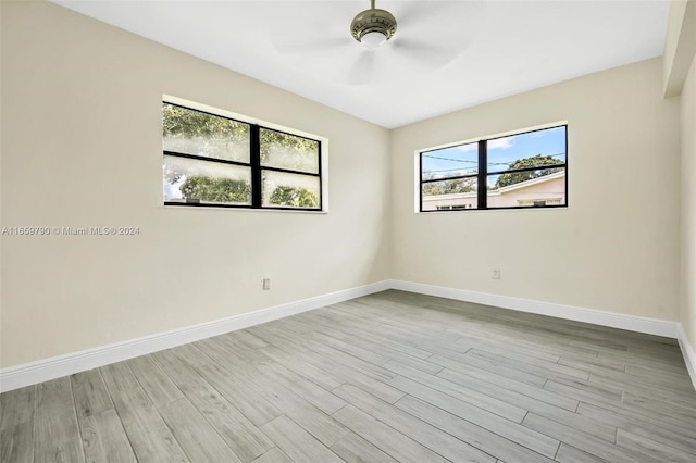 unfurnished room with ceiling fan and light wood-type flooring