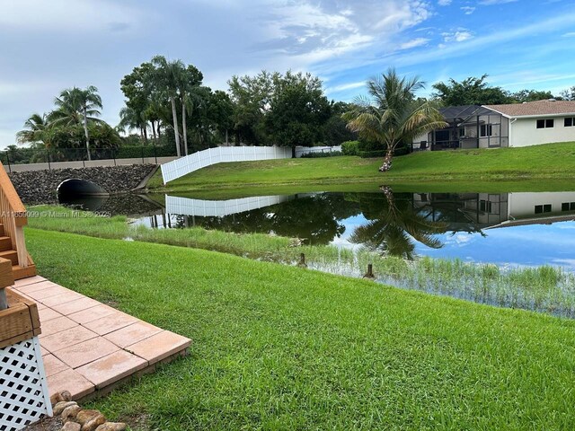 exterior space with a water view and a yard