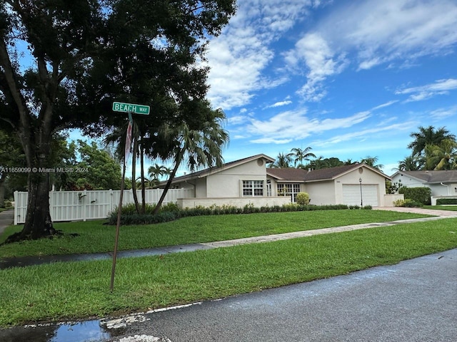 ranch-style house featuring a garage and a front yard