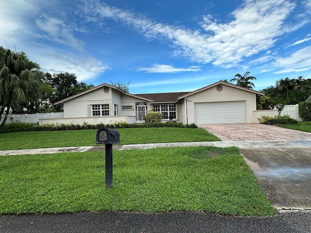 ranch-style house featuring a garage and a front yard