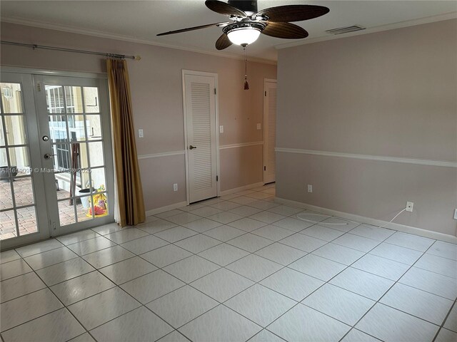 empty room featuring french doors, ceiling fan, ornamental molding, and light tile patterned floors