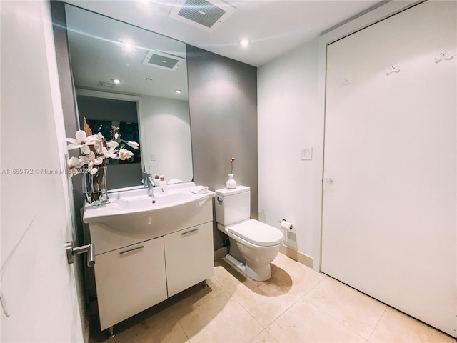 bathroom featuring vanity, toilet, and tile patterned flooring