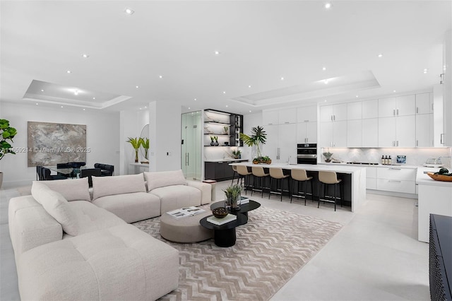 living room with a tray ceiling