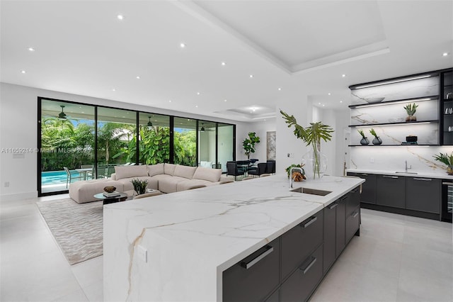 7001 SW 71st Ave, Miami, FL 33143 - kitchen with modern cabinets, a center island with sink, open shelves, open floor plan, and a sink